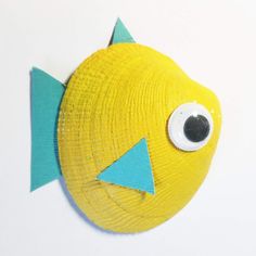 a close up of a paper plate with a yellow fish on it's face