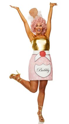 a woman dressed in a pink and gold costume with her arms up, legs apart