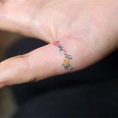 a person with a small tattoo on their left hand