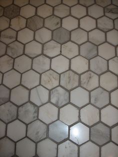 an image of a marble floor with hexagonal tiles on it's sides