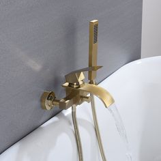 a faucet with water running from it in a bathtub next to a wall