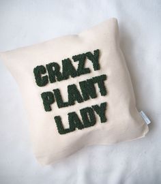 a pillow with the words crazy plant lady embroidered on it's front and back