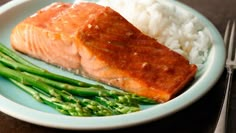 a plate with salmon, rice and asparagus on it