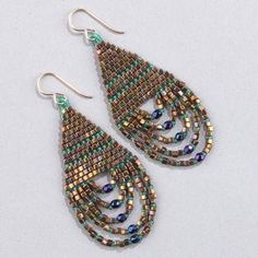 a pair of earrings with multicolored beads