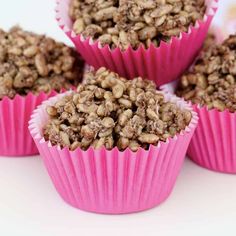 four pink cupcakes filled with granola on top of each other