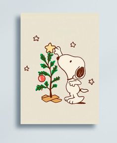 a snoopy christmas card with a tree and star on it