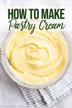 a glass bowl filled with creamy cream on top of a white tablecloth next to a napkin