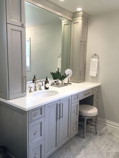 a large bathroom with two sinks and mirrors