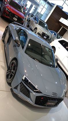 several cars are on display in a showroom