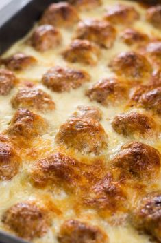 a casserole dish with meatballs and cheese in it, ready to be eaten