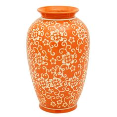 an orange vase with white designs on the outside and inside, sitting against a white background