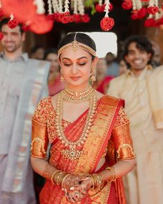 a woman in an orange and gold bridal outfit