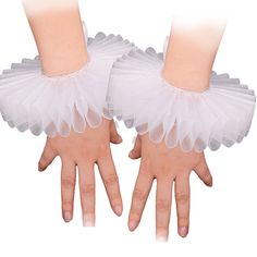 two hands with white tulle gloves on them