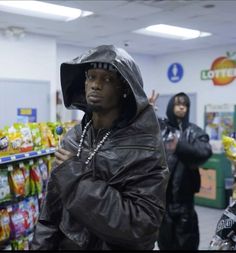 a man wearing a hoodie in a grocery store