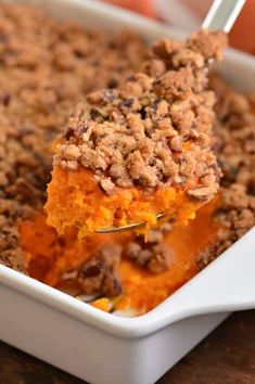 a close up of a casserole dish on a spoon with crumbled topping