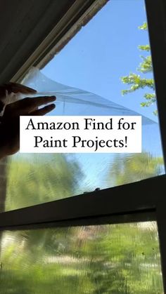 someone is looking out the window with an umbrella over their head and text that reads, amazon find for paint projects