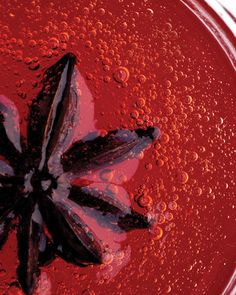 a close up view of an orange juice with water droplets on the surface and around it