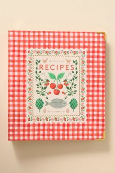 a red and white checkered table cloth with an image of cherries on it