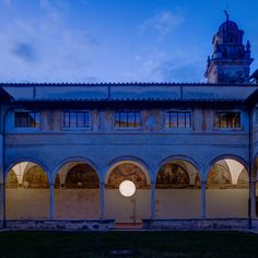 an old building with arches and windows at dusk