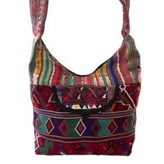 Huipil Hobo Bag handmade by Guatemalan artisans made from a repurposed "Huipil", a traditional Mayan blouse used by Guatemalan women. Fully lined with a zip top and one front pocket. perfect as travel bag, very roomy and lightweight.Details: 100% cotton textiles made entirely by hand in GuatemalaBlack lining Approximate size dimensions: 15.5"x15.5"Padded handle Up-cycled vintage embroidery in the front and backZipper ClosureFront pocket When buying up-cycle vintage clothing, many times you will Bohemian Multicolor Shoulder Bag For Trip, Multicolor Trip Bag With Pockets, Multicolor Travel Bag With Pockets, Multicolor Bohemian Bags For Trip, Traditional Patchwork Shoulder Bag For Everyday, Traditional Hobo Shoulder Bag For Everyday Use, Bohemian Shoulder Bag With Zipper Pocket For Travel, Bohemian Multicolor Bags With Pockets, Traditional Handwoven Hobo Bag For Travel