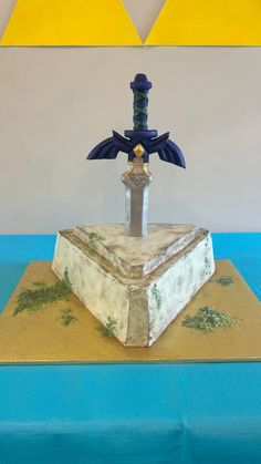 I made this cake for my son’s 9th birthday party. He is really into Breath of the Wild and requested the Master sword in the stone. We molded the sword around a dowel with a blend of fondant and modeling chocolate. Legend Of Zelda Birthday, 9th Birthday Party, Wilton Cake Decorating, 9th Birthday Parties, Modeling Chocolate, Kids' Party, 13th Birthday