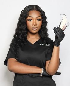 a woman with long hair and black gloves is holding two silver objects in her hands