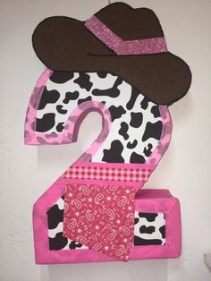 the number two is made out of cow print fabric and has a cowboy hat on it