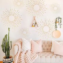 a living room with couches, pillows and plants