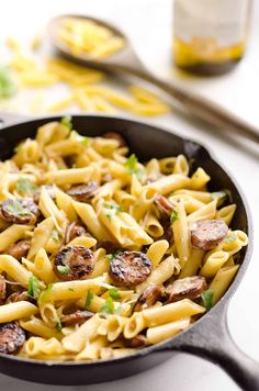 a skillet filled with pasta and sausage