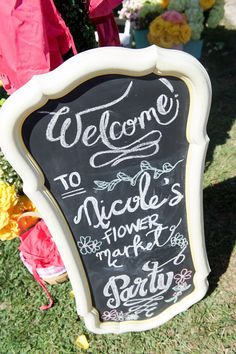 a chalkboard sign that says welcome to nicole's flower market party on it