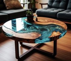 a wooden table with a glass top in a living room next to a couch and coffee table