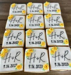 wedding cookies decorated with yellow roses and the names of bride and groom on each cookie