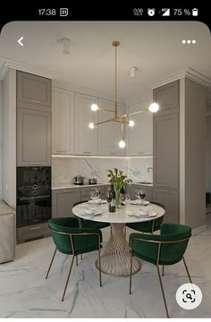 a dining table with four chairs and a vase on it in the middle of a kitchen