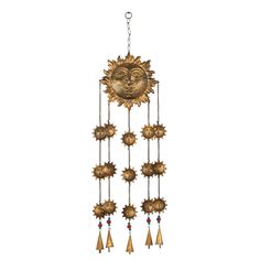 a sun and moon wind chime hanging from a chain on a white background with red beads