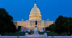 the united states capitol building lit up at night