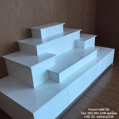 there are three white boxes stacked on top of each other in the same room with wood flooring