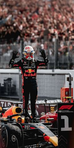 a man standing on top of a race car