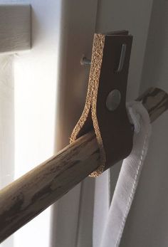 a piece of wood sticking out of the side of a door with a hook on it