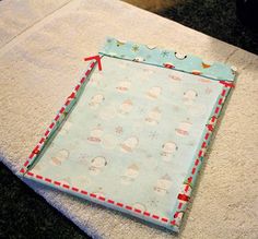 a close up of a piece of cloth on top of a table with a cat in the background