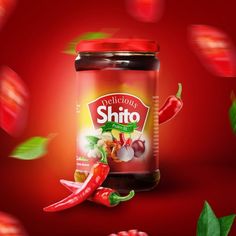 a jar of chili sauce with peppers and leaves flying around it on a red background