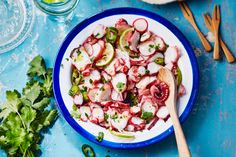 a blue and white bowl filled with sliced radishes on top of a table