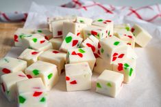 a pile of white and green dice sitting on top of a table