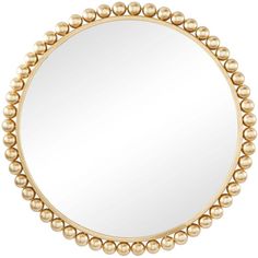 a round mirror with gold beads on the edges and an oval frame, in front of a white background