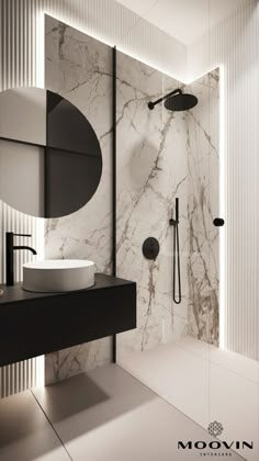 a bathroom with marble walls and flooring in black, white and grey colors is shown