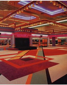 an empty lobby with colorful carpeting and chandeliers