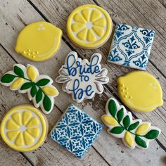 decorated cookies with lemons and leaves are arranged on a table