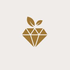 an apple with leaves on it and the shape of a diamond is shown in gold