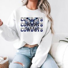 Show off your love for the Cowboys with this Cowboys Rhinestone Bow Sweatshirt. Perfect for sports fans, this cozy and stylish sweatshirt is a great addition to your wardrobe. It exudes a fun and flirty vibe, making it ideal for game days or casual outings with friends. Product features - Knit in one piece without side seams for a more attractive look - Ribbed knit collar for elasticity and shape retention - Made with a medium-heavy fabric blend of 50% cotton and 50% polyester for coziness in colder months - Classic fit and crew neckline for a comfy wearing experience - Durable double-needle stitching at key seams for longevity Care instructions - Machine wash: cold (max 30C or 90F) - Non-chlorine: bleach as needed - Tumble dry: low heat - Do not iron - Do not dryclean Coquette Sweatshirt, Cowboys Sweatshirt, Dallas Cowboys Sweatshirt, Bow Sweatshirt, Cowboy Girl, Rhinestone Bow, Cow Boy, Look Plus, Sports Fan