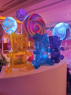 there are many colorful candies on display in the store