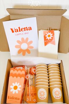 an open box filled with orange and white items next to a sign that says valena